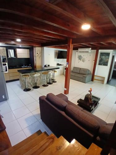a living room with a couch and a kitchen at Sharick Beach House in Tubará