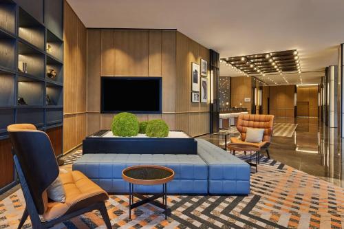 a living room with a blue couch and a tv at Four Points by Sheraton Dali, Erhai in Dali