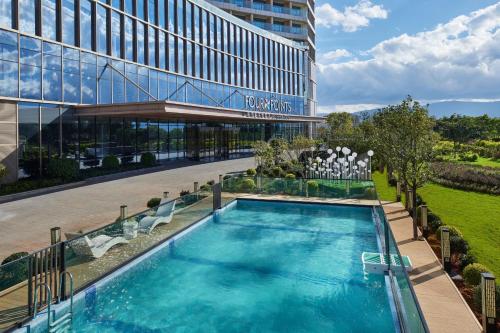 a swimming pool in front of a building at Four Points by Sheraton Dali, Erhai in Dali