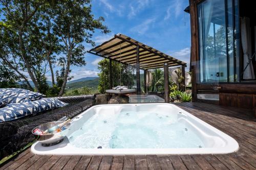 a jacuzzi tub on the deck of a house at Riviera Santo Antônio in Florianópolis