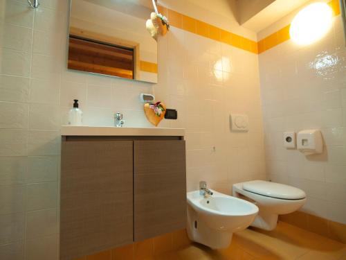 a bathroom with a toilet and a sink at La Locandiera in Carona