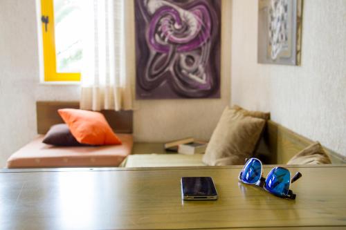 a living room with a couch and a table with shoes at Lycasti Maisonettes in Tavronitis