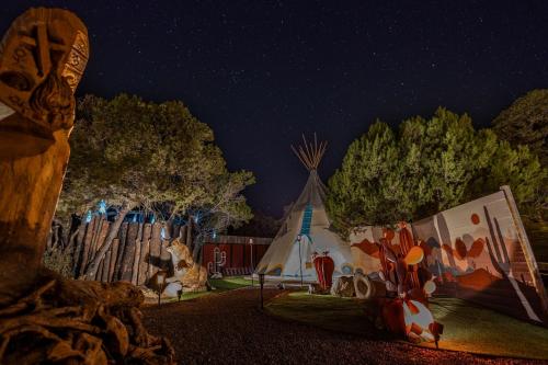 a night view of a park with a tent and trees at Toro Tipi at El Mistico Ranch in Nogal