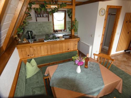 a dining room with a table and a kitchen at Ferienhaus in Sebnitz in Sebnitz