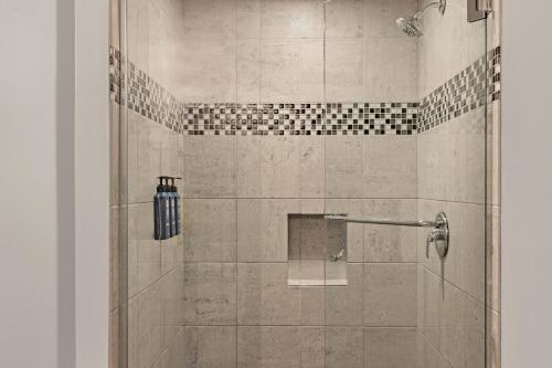 a bathroom with a shower with a glass door at Deluxe Union Square Suites in San Francisco