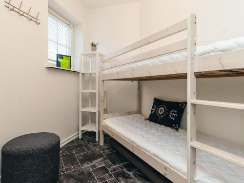 a room with two bunk beds and a chair at 4 star holiday home in Bogense-By Traum in Bogense