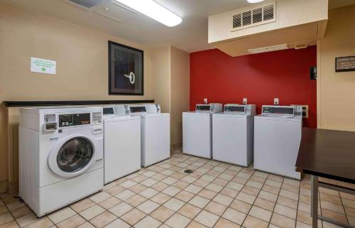 a laundry room with four washing machines and a table at Extended Stay America Suites - Orlando - Altamonte Springs in Orlando