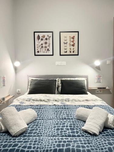 a bedroom with a bed with two pillows on it at BlueLine apartment 3 in Loutraki