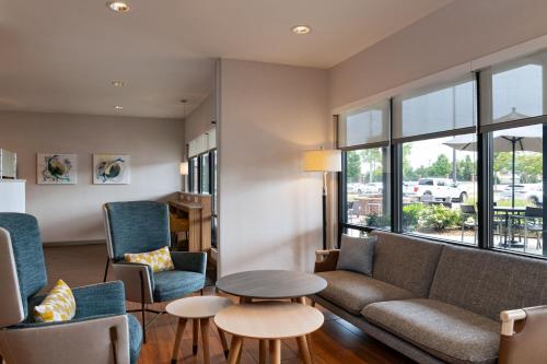 a living room with a couch and chairs and a table at TownePlace Suites by Marriott Macon Mercer University in Macon