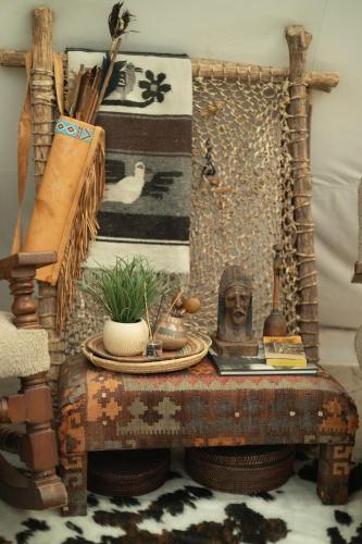 an old table with a bust on top of it at Oso Tipi at El Mistico Ranch in Nogal
