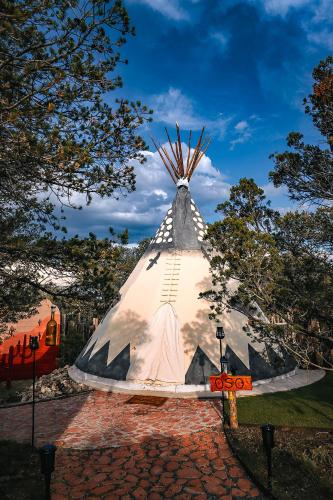 a large pyramid with a sign in front of it at Oso Tipi at El Mistico Ranch in Nogal