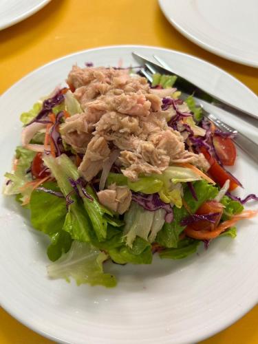 a salad on a white plate on a table at Rin Bay View Resort in Haad Rin