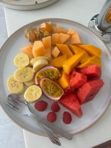 a plate of fruits and vegetables on a table at Rin Bay View Resort in Haad Rin