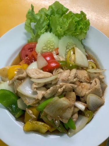 a white plate of food with chicken and vegetables at Rin Bay View Resort in Haad Rin