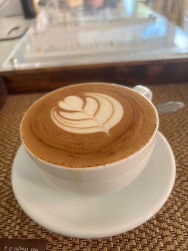 a cup of coffee on a plate on a table at Rin Bay View Resort in Haad Rin