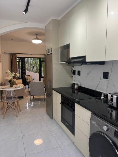 a kitchen with a stove and a dishwasher at 10 Lagoon Cabanas Ramsgate in Margate