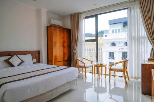 a hotel room with a bed and a large window at Ngan Ha Hotel Tam Dao Panorama View in Tam Ðảo