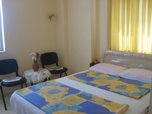 a bedroom with a bed and two tables and chairs at Botanik Ferienhaus in Side