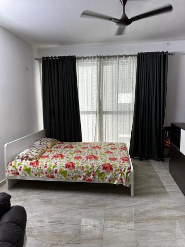a bedroom with a bed in front of a window at Cosy nest in Hyderabad