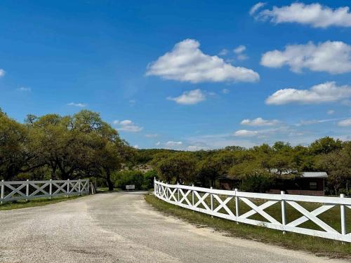 a white fence on the side of a road at CRC Ranch Retreat in Bandera