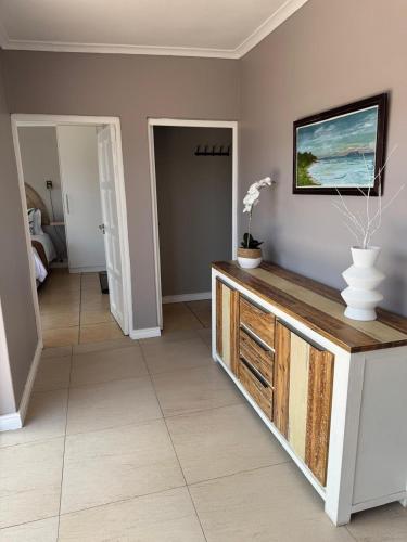 a living room with a tv on a wall at Luxury Beachfront Villa in Langebaan