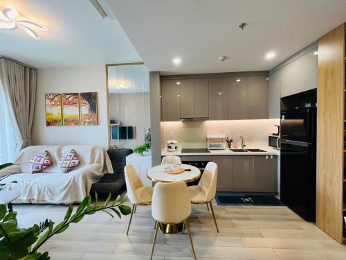 a kitchen and a living room with a table and chairs at Masteri Centre Point - Vihomes serviced apartment in Long Bình