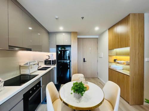 a kitchen with a table and chairs in a room at Masteri Centre Point - Vihomes serviced apartment in Long Bình