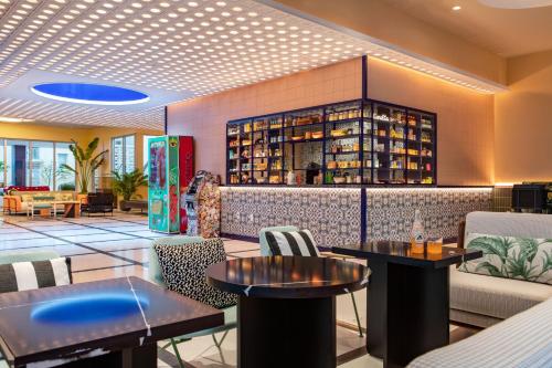 a restaurant with two tables and a bar at Moxy Miami South Beach in Miami Beach