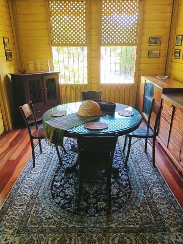 a dining room with a table and chairs at Bagas Zakariah Orchard Lodge in Gopeng