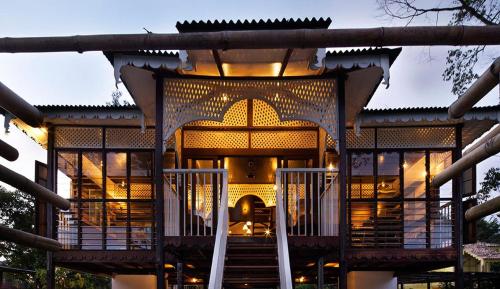 a building with a staircase in front of it at Bagas Zakariah Orchard Lodge in Gopeng