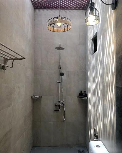 a bathroom with a shower and a sink at Bagas Zakariah Orchard Lodge in Gopeng