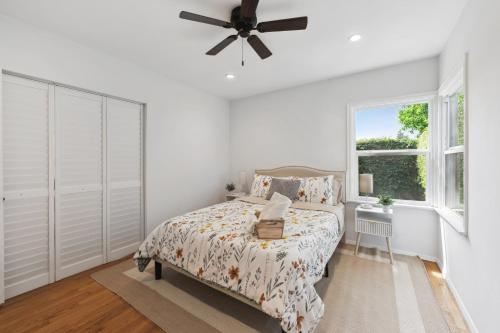 a white bedroom with a bed and a window at Cosy 3BD by Santa Monica - Beach & Airport 10 min away in Los Angeles