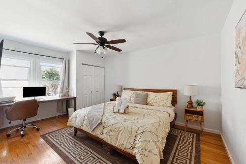a bedroom with a bed with a desk and a ceiling fan at Cosy 3BD by Santa Monica - Beach & Airport 10 min away in Los Angeles