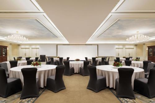 a conference room with white tables and chairs and chandeliers at The Westin Tokyo in Tokyo