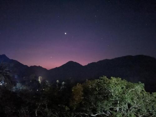 a night view of the mountains with the stars at Cliff Canvas in Mount Ābu