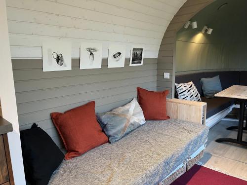 a bed in a room with pictures on the wall at Stall & Sterne - Tiny Häuser in Hirschfeld