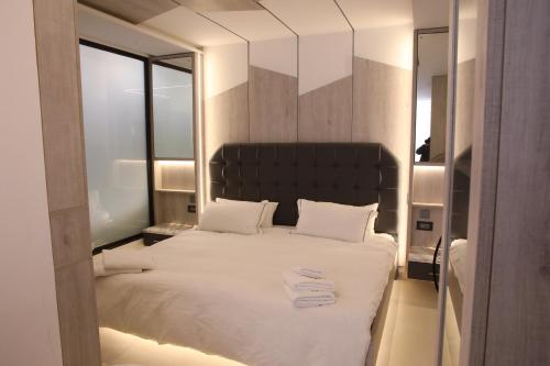 a bedroom with a large bed with white sheets and pillows at Casa El Haje in Al Maşyaf