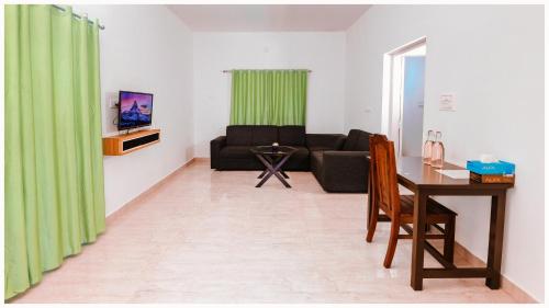 a living room with a couch and a table at Vajra Ayurveda and Yoga Retreat in Cochin