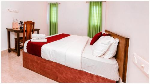 a bedroom with a bed with white and red sheets at Vajra Ayurveda and Yoga Retreat in Cochin