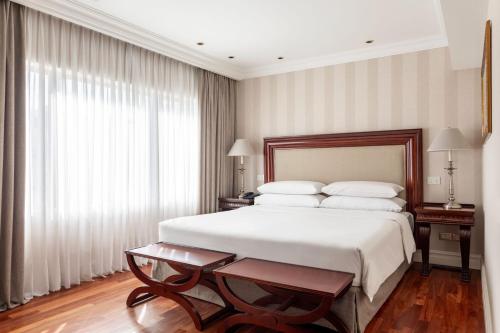 a bedroom with a large white bed and a window at Buenos Aires Marriott in Buenos Aires