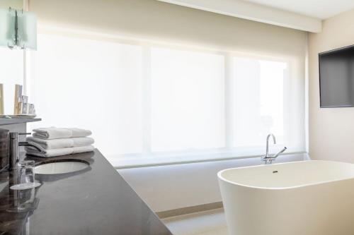 a bathroom with a white tub and a sink at Buenos Aires Marriott in Buenos Aires