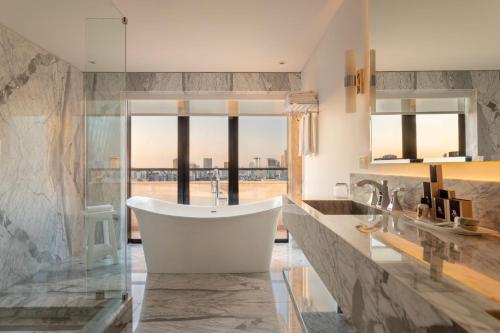 a bathroom with a tub and a large window at Buenos Aires Marriott in Buenos Aires