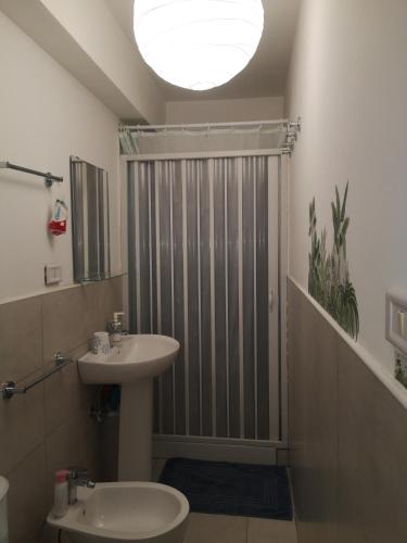 a bathroom with a sink and a shower at La terrazza sul mare in Letojanni