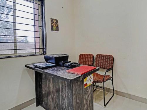 an office with a desk with a laptop and a chair at Super HOTEL O MIDWAY TREAT DHAR in Dhār