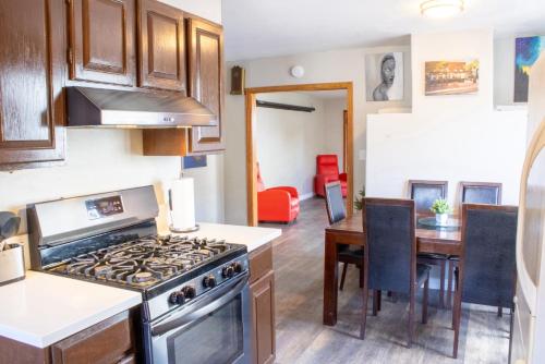 a kitchen with a stove and a dining room at Private Home - #RedwoodSkyWalkRetreat - 5BD, Pro Pool Table, BBQ, Foosball, Darts, Fireplace, Movie Projector, Stereo, Cotton Bedding in Eureka