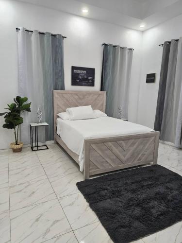 a bedroom with a large bed and a rug at Blanco Oasis in Banks