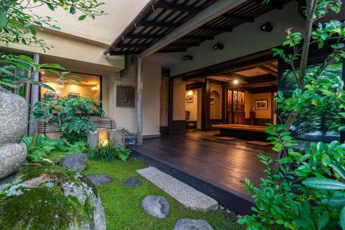 a house with a wooden floor and a porch at Taikyourou in Miyazu