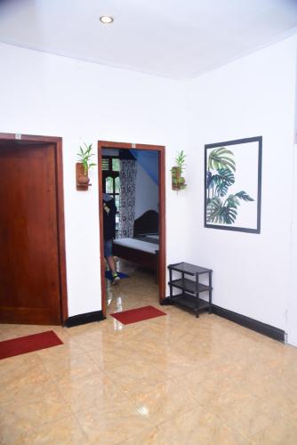 a room with a door leading to a room with a couch at Travel rest inn in Ella