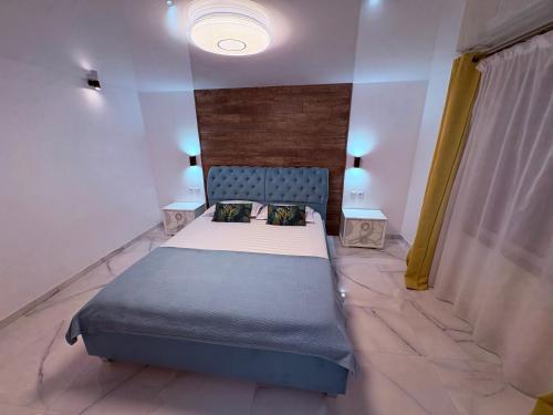 a bedroom with a bed and two night stands at Casuta din livada in Botoşani