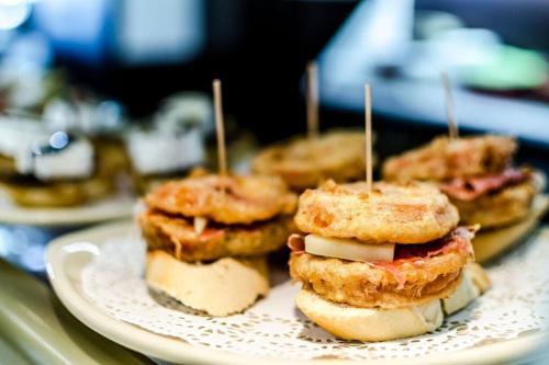a plate with three sandwiches on a table at Hotel Apolonia Soria in Soria